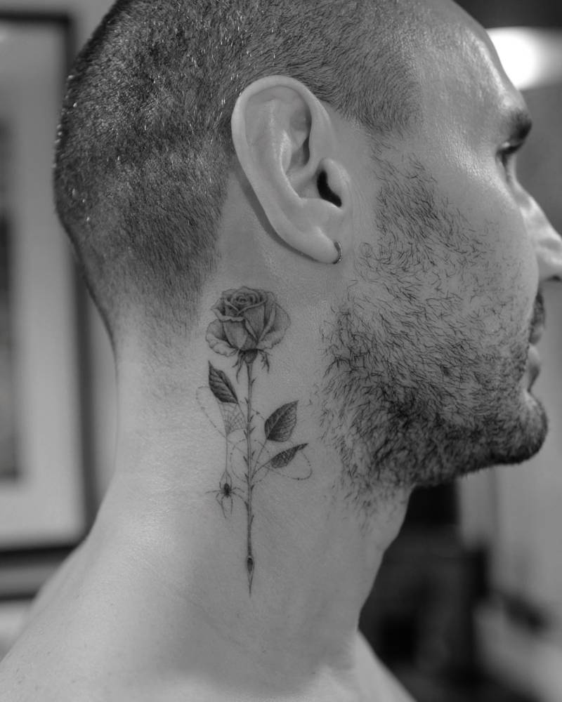 Micro-realistic style rose and spider tattoo located on the neck.