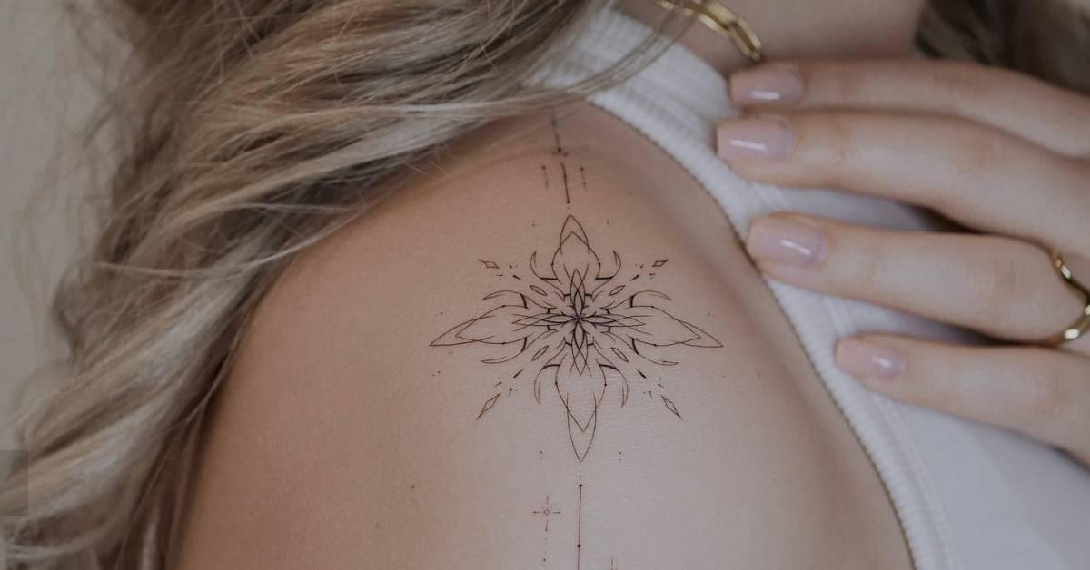 Fine line style ornamental tattoo located on the