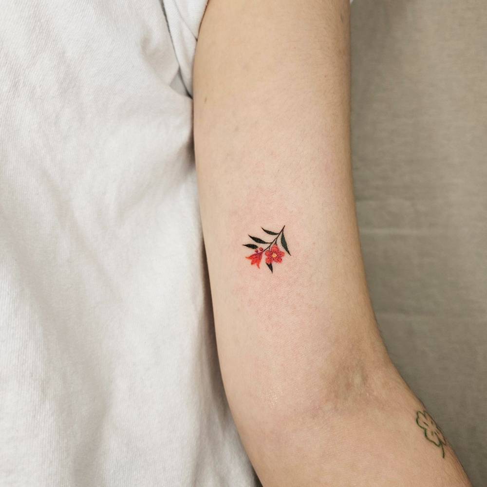 Cute watercolor style flower tattoo located on the inner arm.