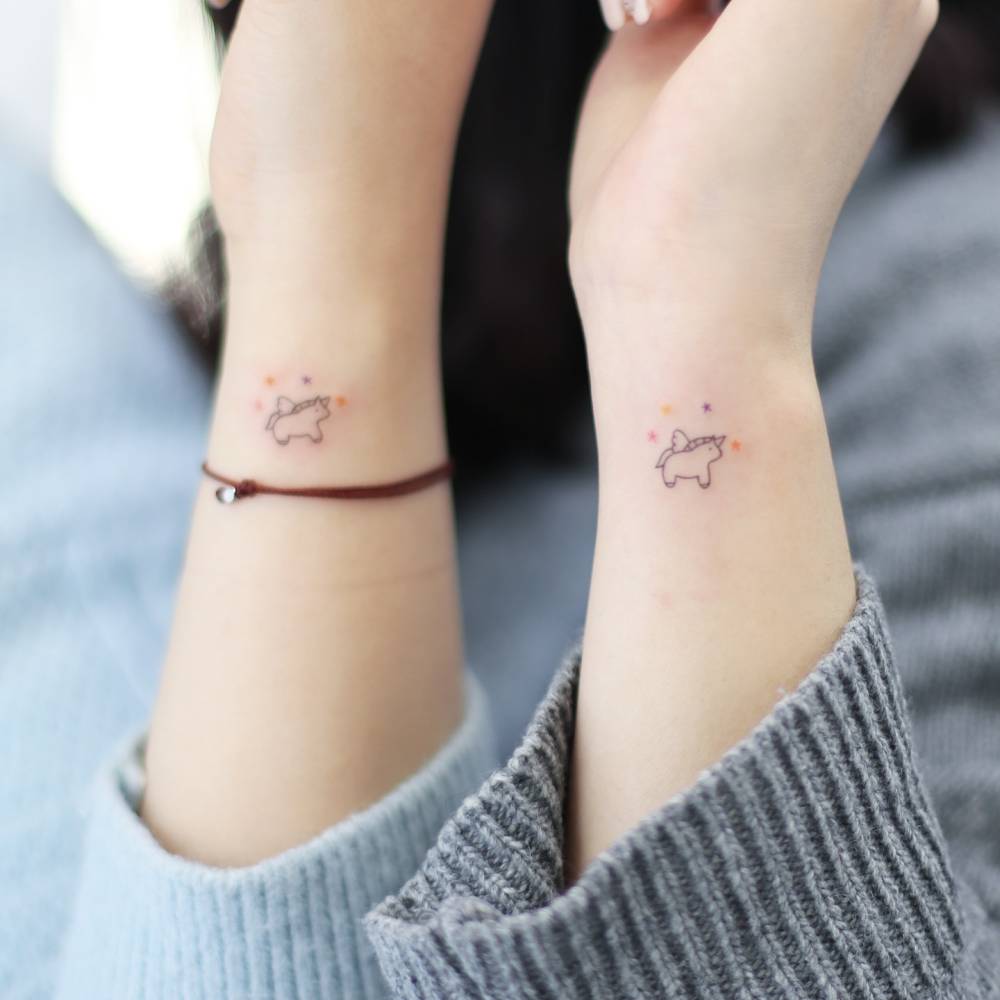 Matching minimalistic style unicorn tattoo for best friends.