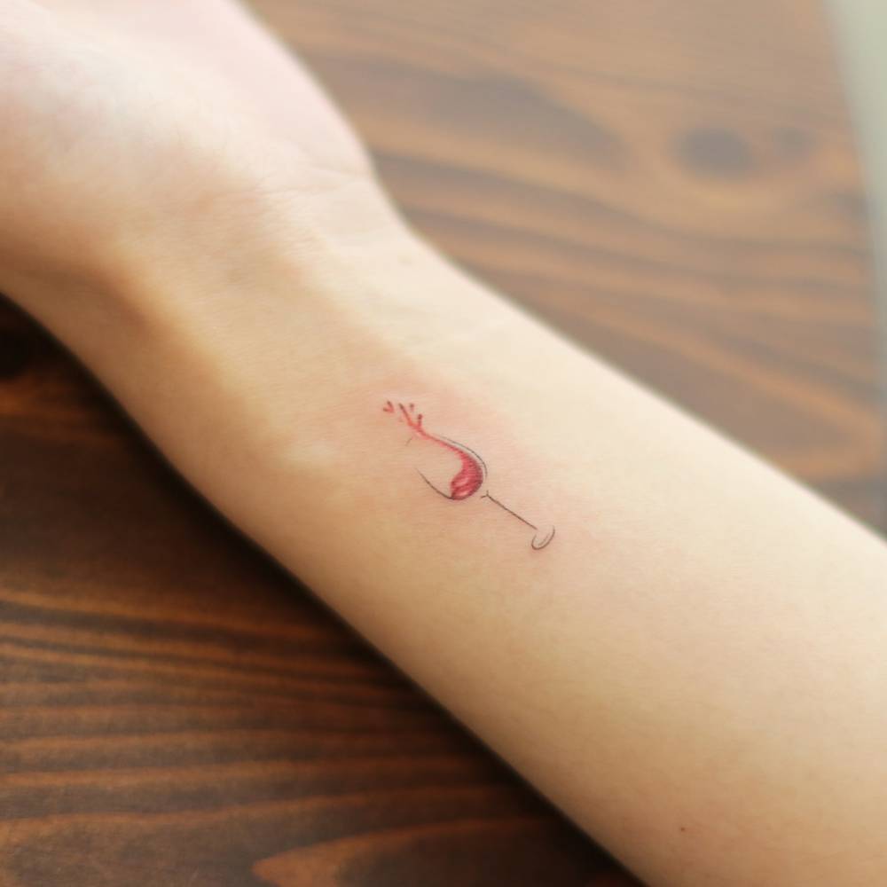 Minimalistic style wine glass tattoo located on the wrist.