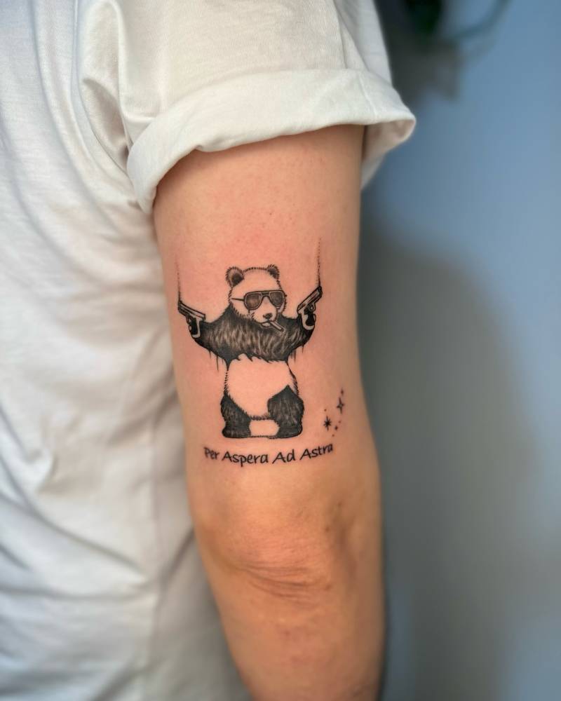 Gangsta panda tattoo located on the tricep.