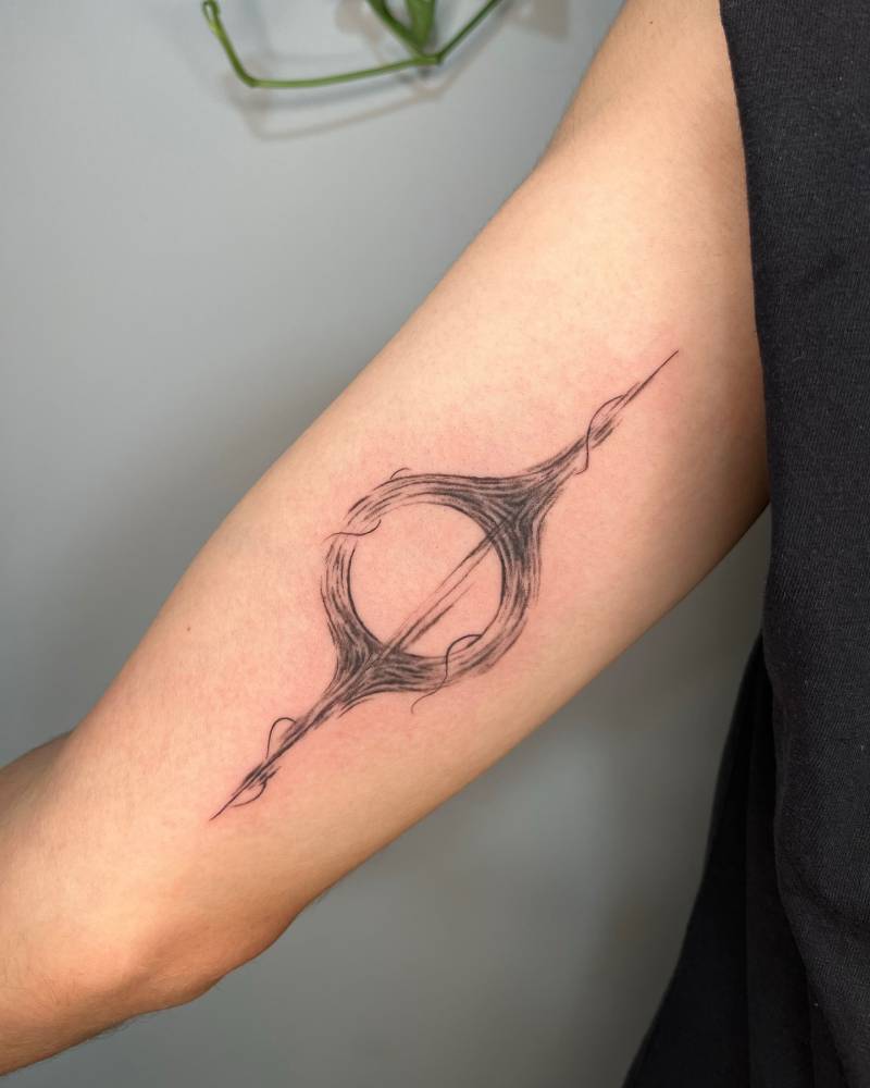 Illustrative style black hole tattoo located on the inner arm.