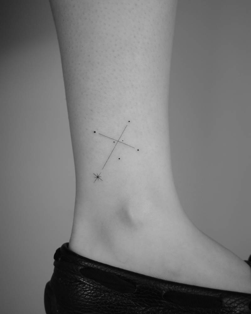 Southern Cross tattoo located on the ankle, minimalistic style.
