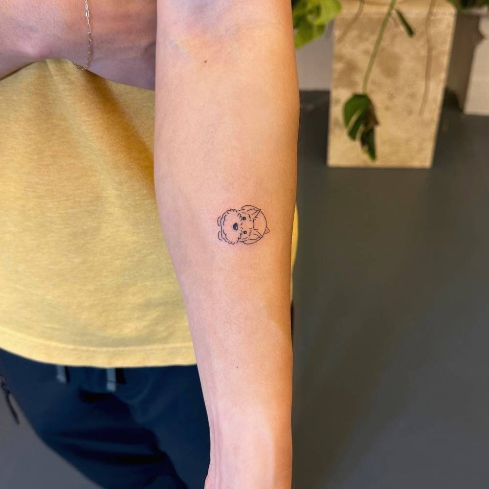 Hand poked schnauzer tattoo located on the inner forearm.