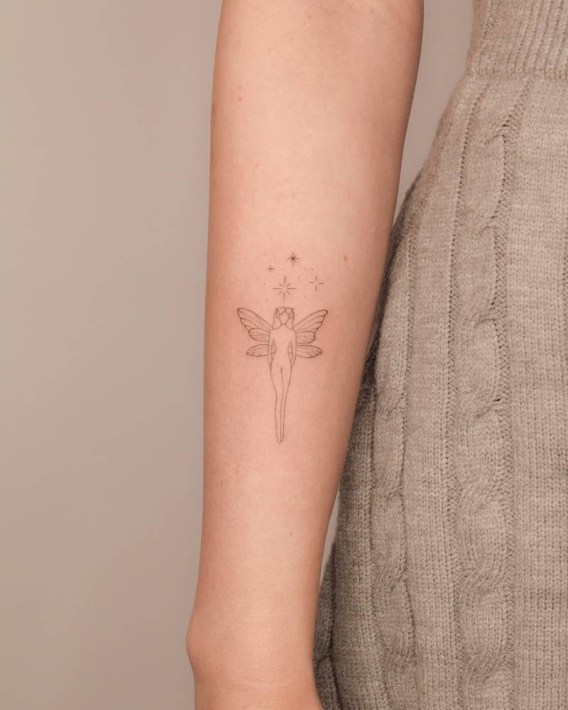 Fairy tattoo placed on the inner forearm, fine line style.