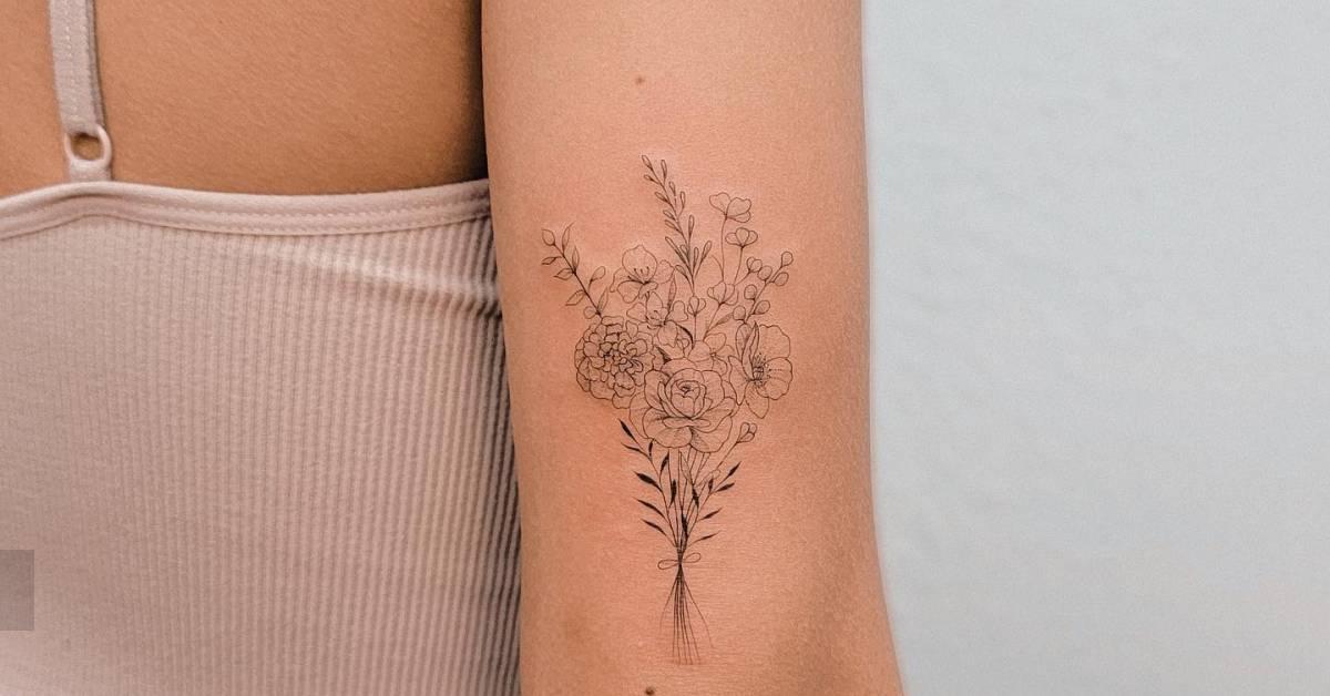 Fine line style flower bouquet tattoo located on the