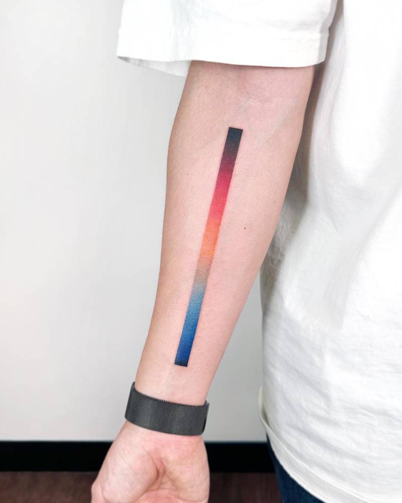 Spectrum line tattoo in watercolor style located on the inner forearm.