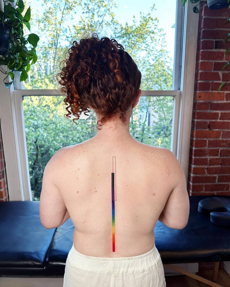Visible spectrum tattoo located on the spine.