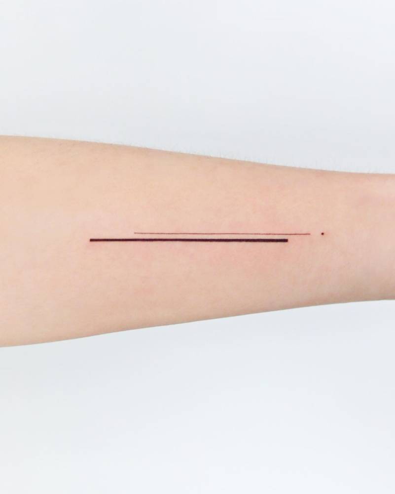 Minimalistic lines tattooed on the wrist.