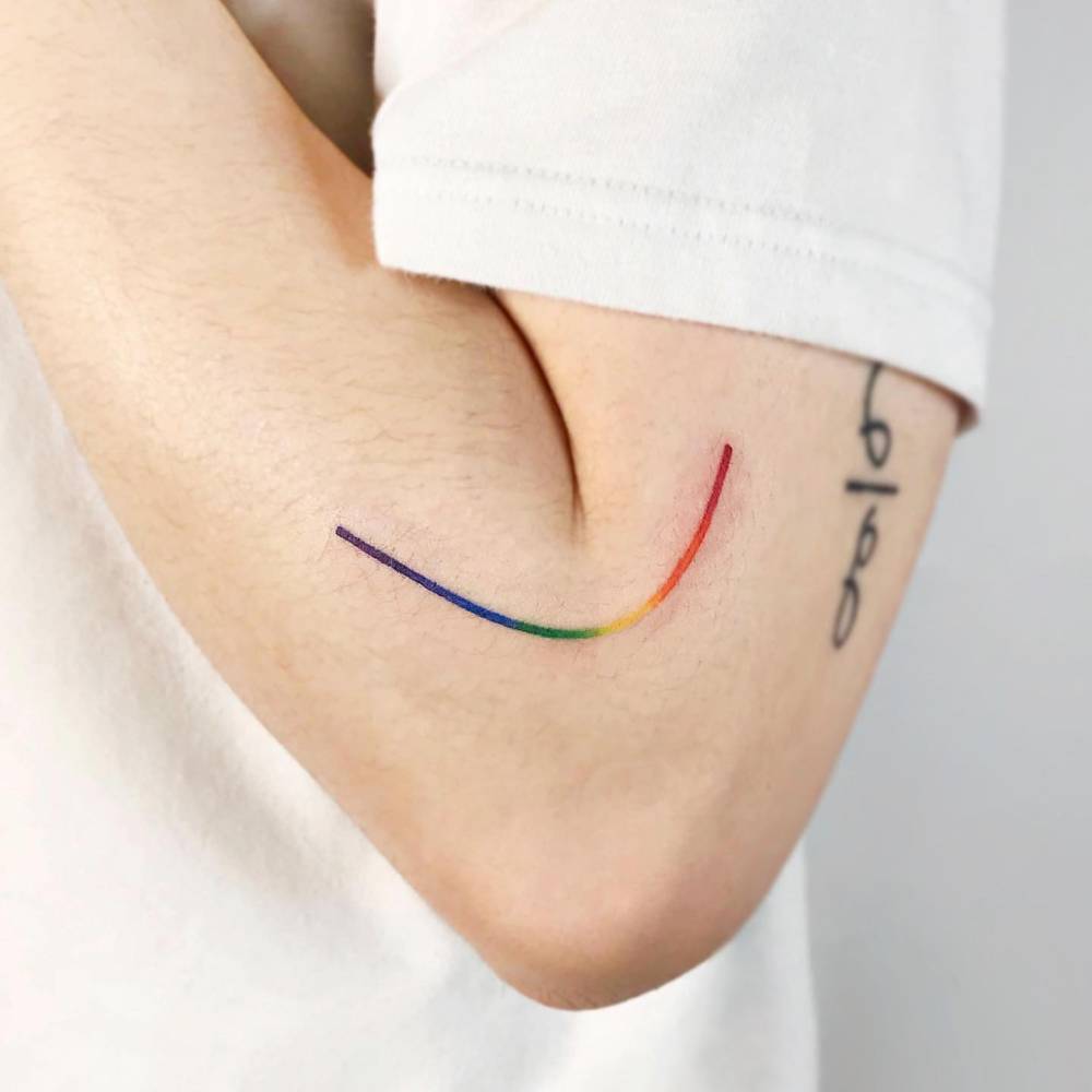 Visible spectrum line tattooed on the elbow.