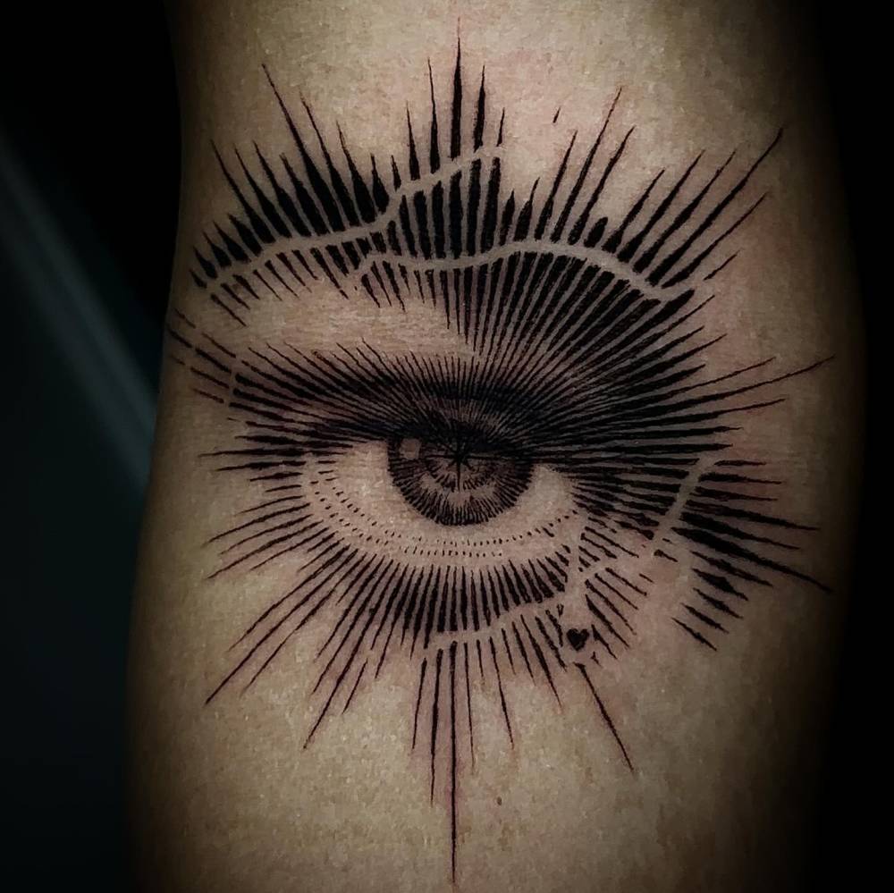 Blackwork style eye tattoo located on the inner forearm.