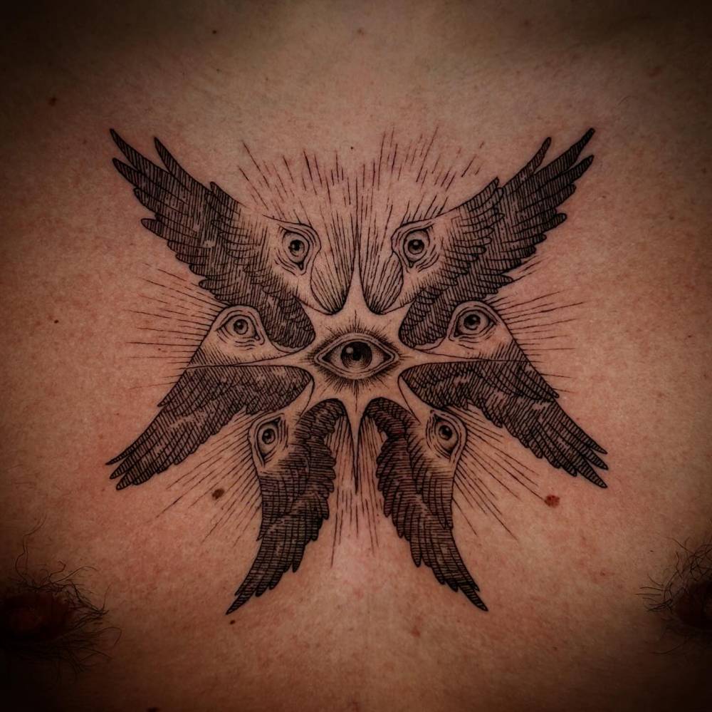 Six winged seraphim tattoo placed on the chest, done in engraving style.