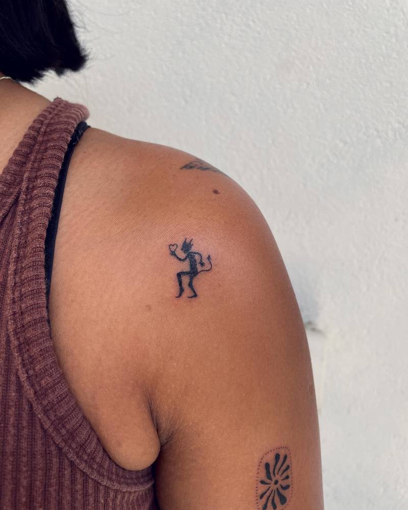 Little minimalistic hand poked devil tattoo located on the shoulder.