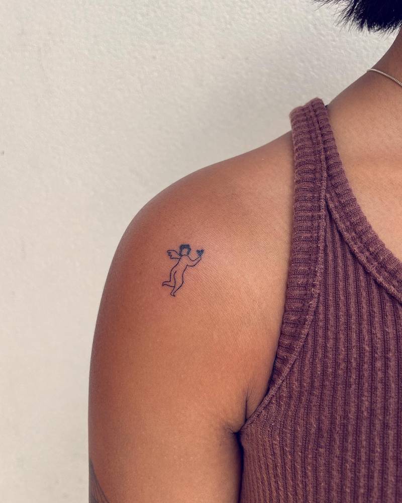 Hand poked angel tattoo placed on the shoulder.