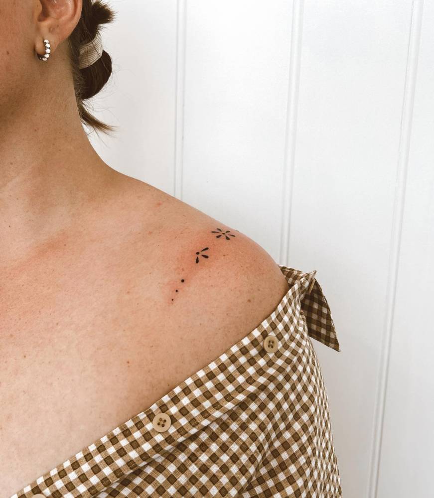 Hand poked ornamental flower tattoo done on the shoulder.