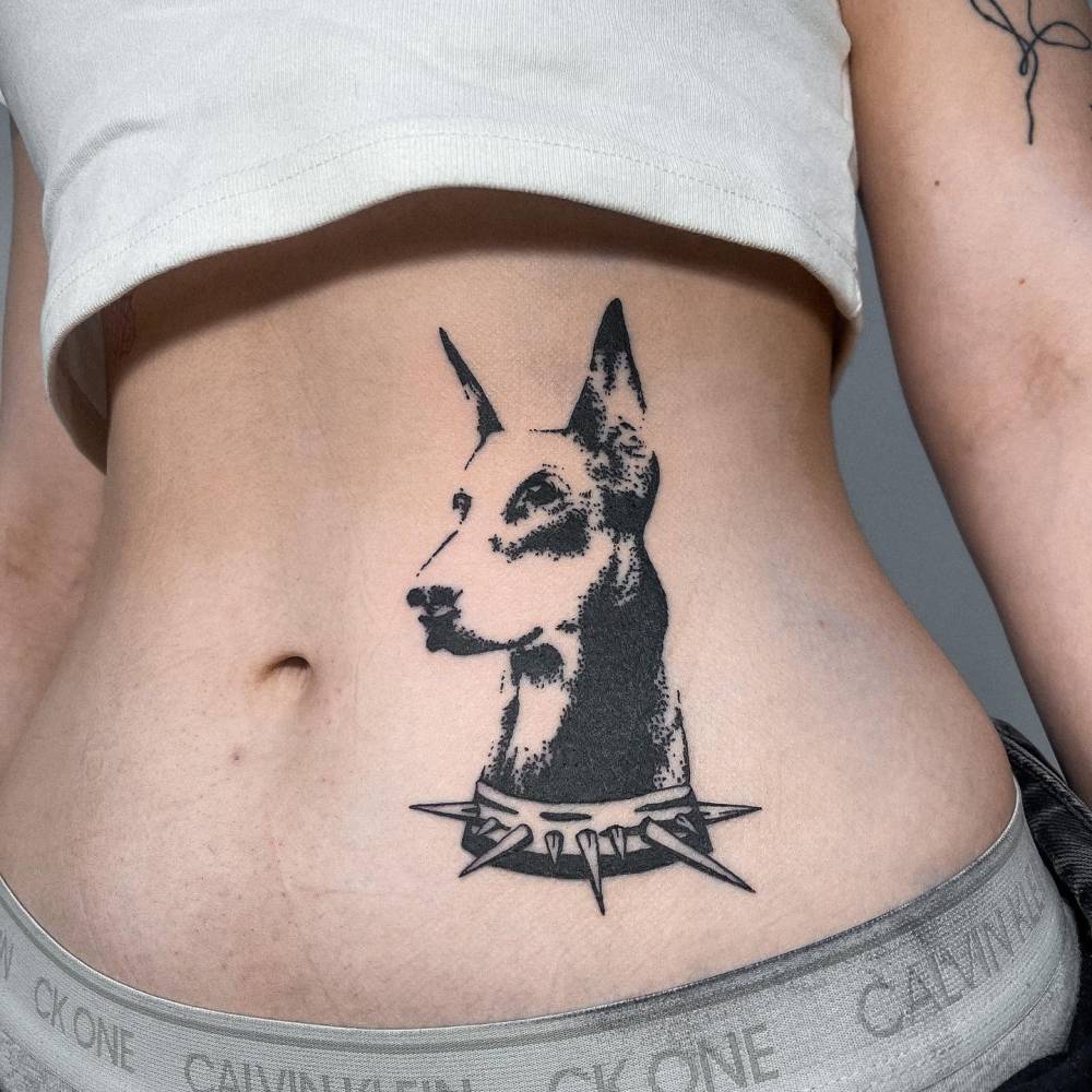 Doberman portrait tattoo located on the waist, blackwork style.