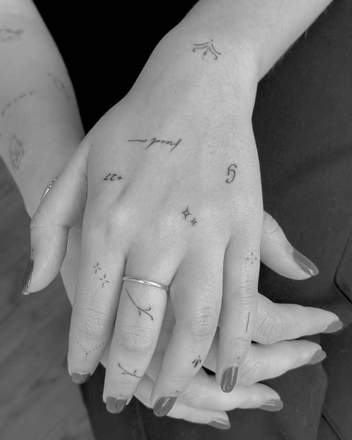 Fine line style hand composition tattoos.