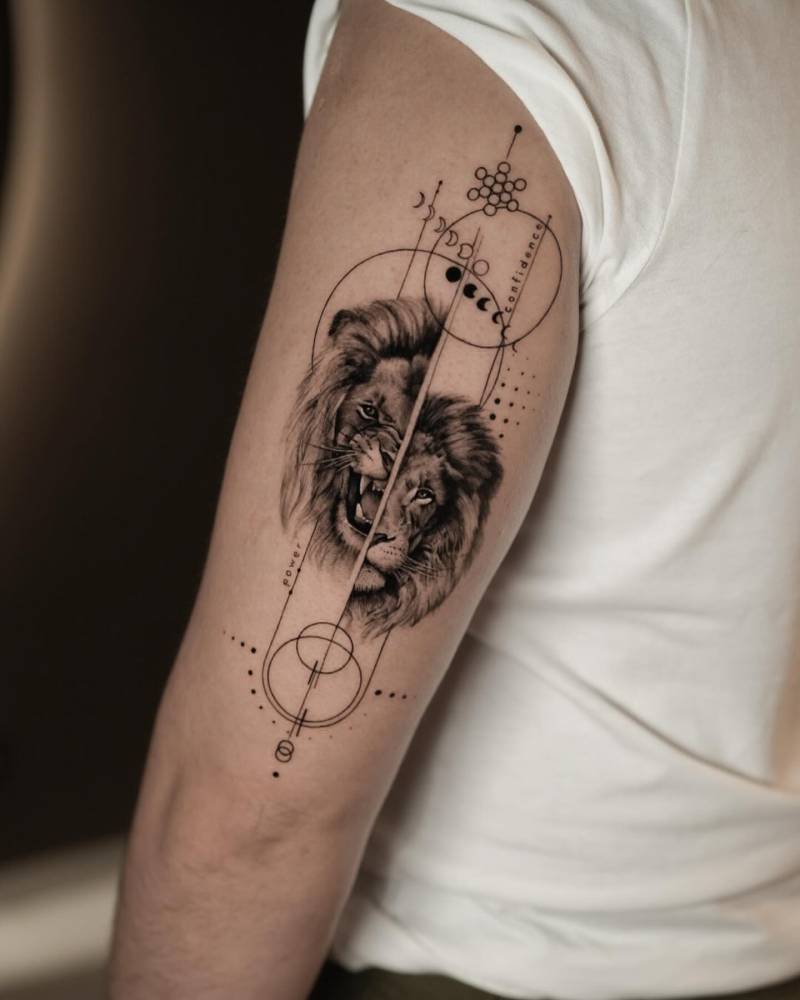 Graphic style lion portrait tattoo located on the tricep.