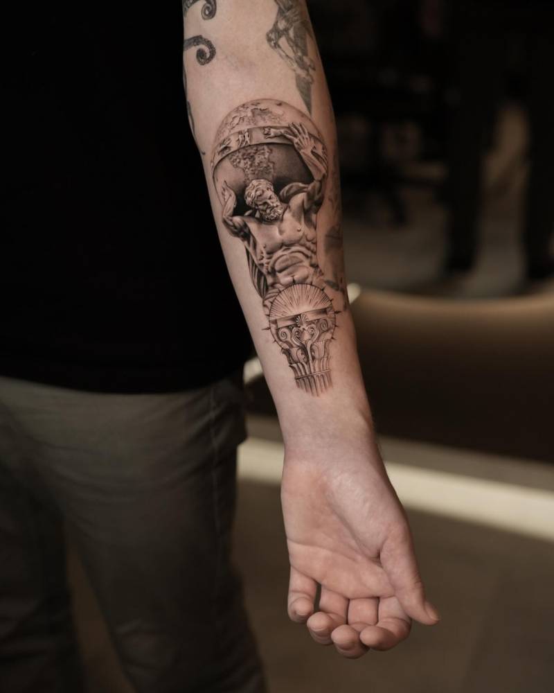 Atlas tattoo placed on the inner forearm, done in black an grey style.