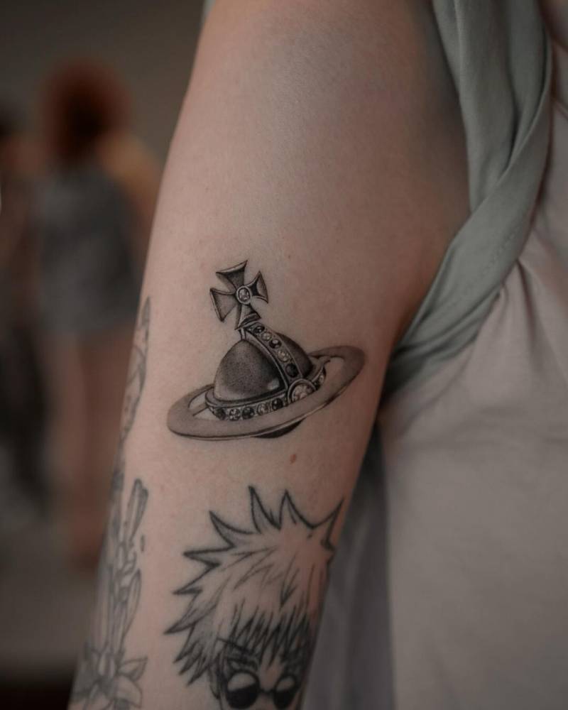 Vivienne Westwood's orb tattooed on the upper arm.