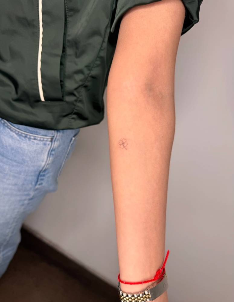 Tiny minimalistic four leaf clover tattoo done on the inner forearm.