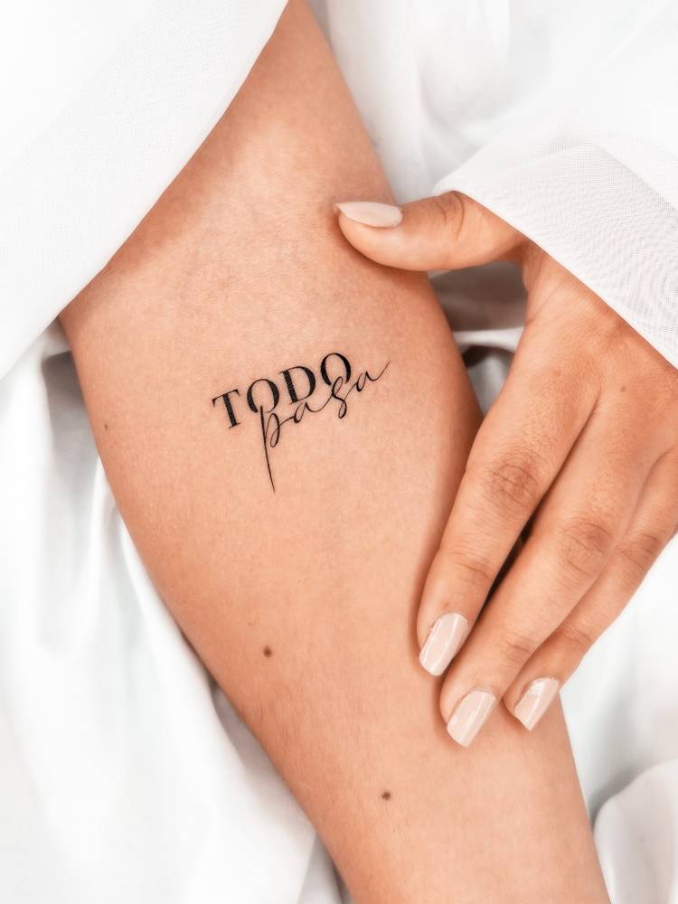 Lettering tattoo that says "todo pasa" located on the inner forearm.