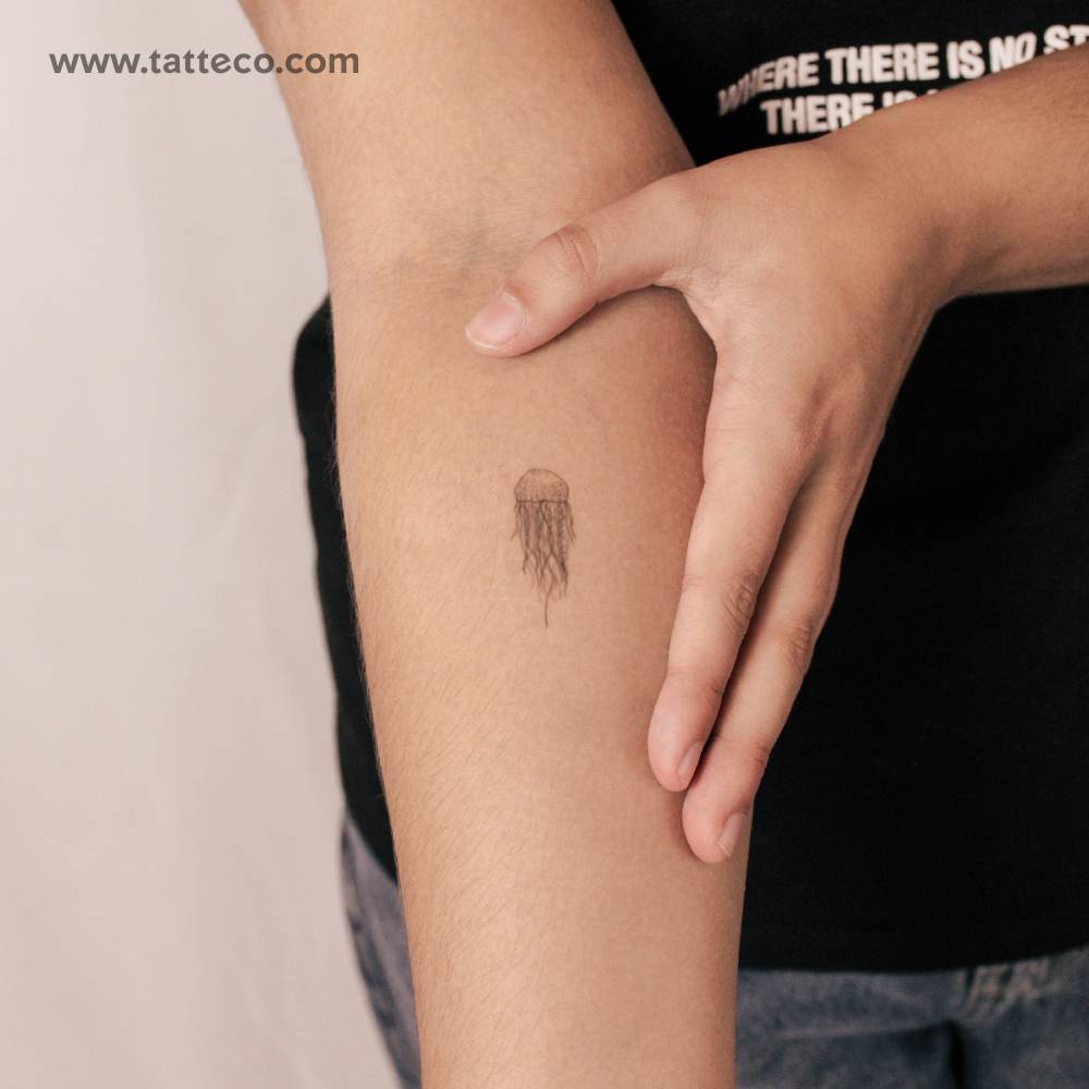 Small illustrative style jellyfish semi-permanent tattoo.