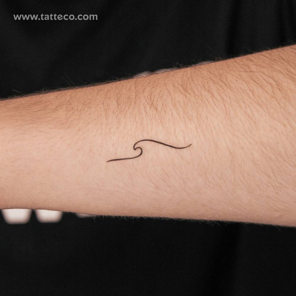 Minimalist style little wave 2-week temporary tattoo located on the forearm.