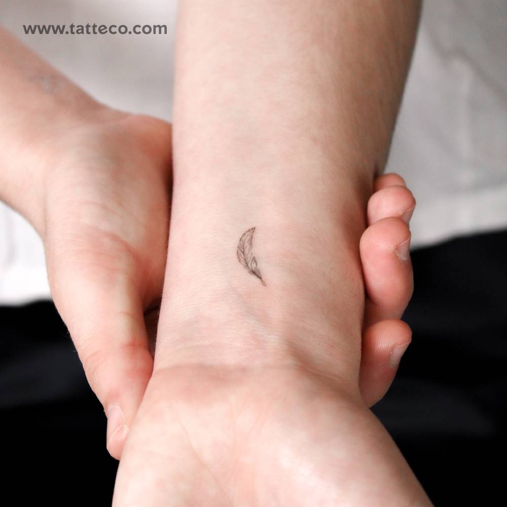 Fine line style little feather semi-permanent tattoo located on the wrist.