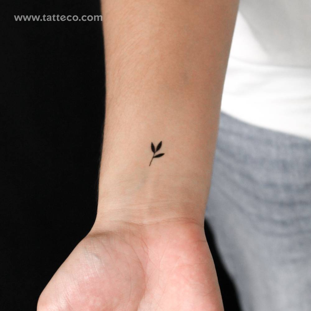 Tiny sprout semi-permanent tattoo in minimalistic style.