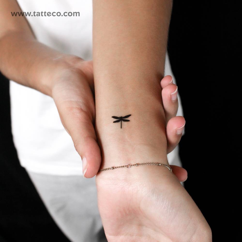 Small dragonfly semi-permanent tattoo located on the wrist.