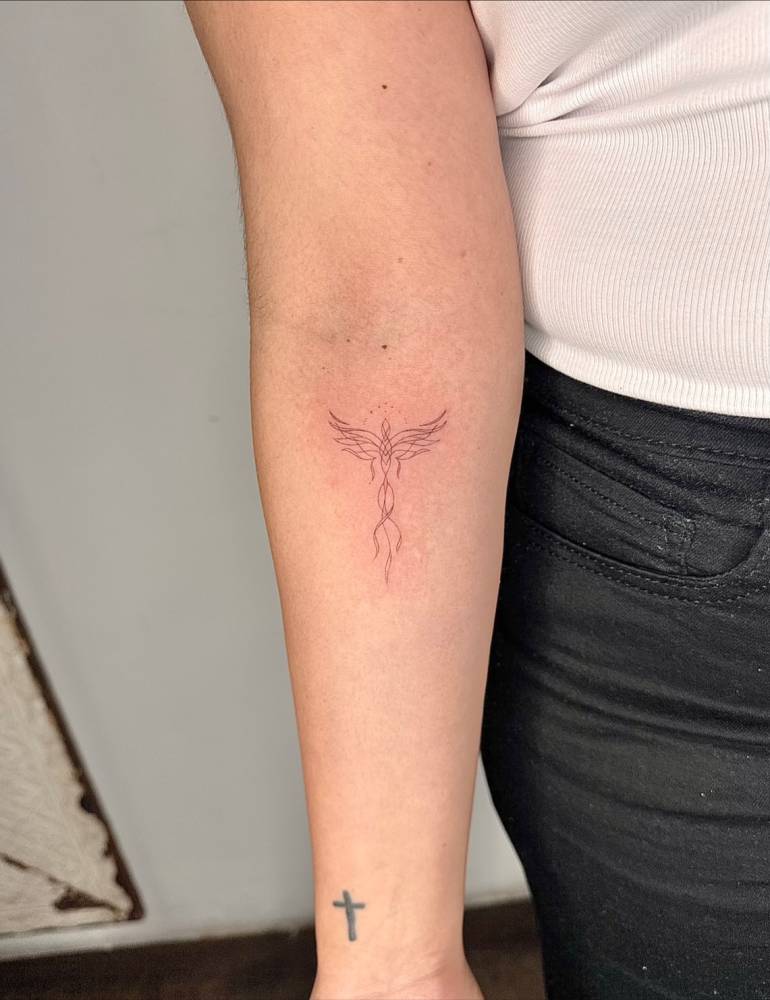 Fine line style phoenix tattoo placed on the inner forearm.