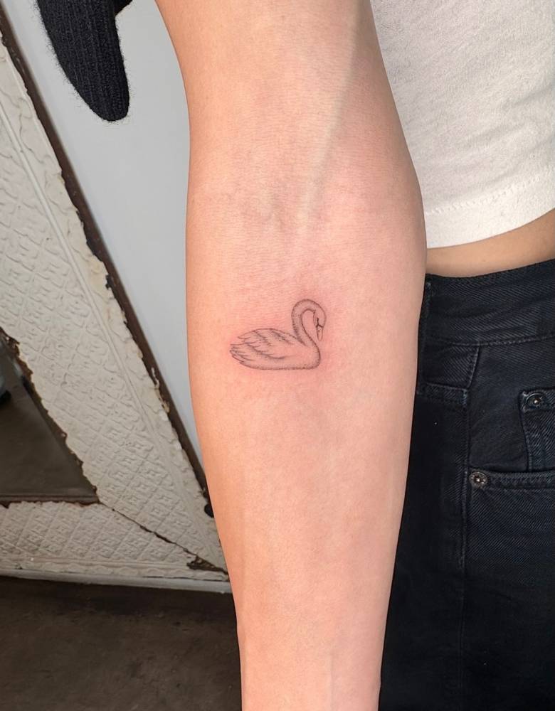Single needle swan tattoo located on the inner forearm.