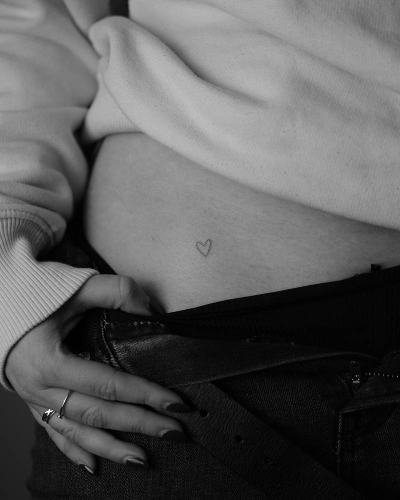 Minimalistic little heart tattoo located on the hip.