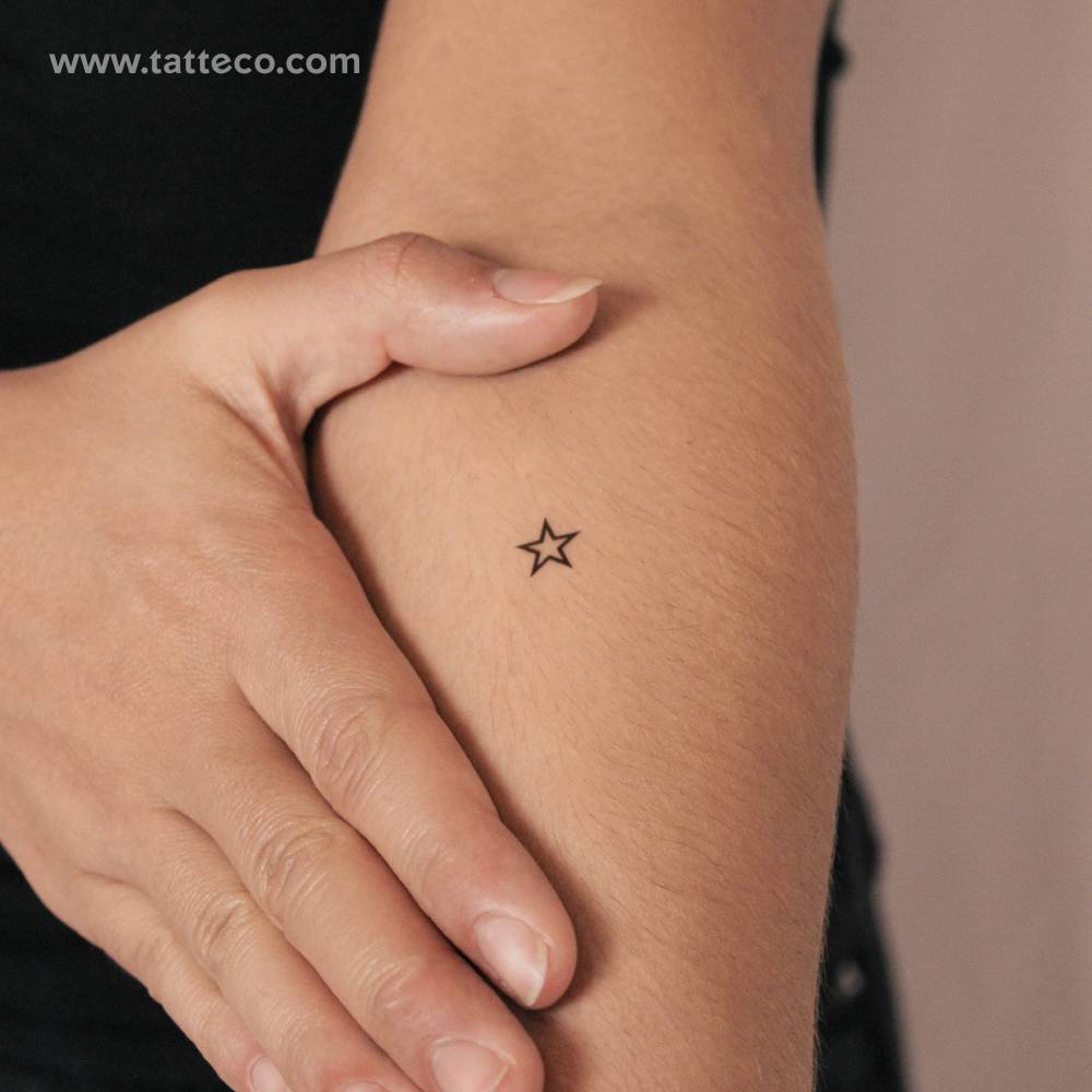 Star outline semi-permanent tattoo located on the inner arm.