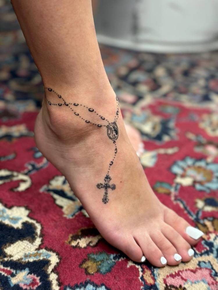 Rosary tattoo located on the ankle and foot.