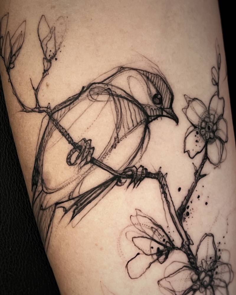 Sketch work style sparrow tattoo located on the inner forearm.
