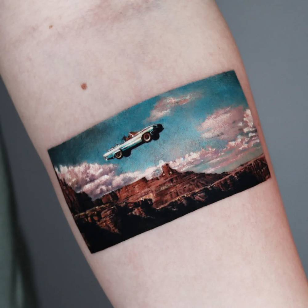 Micro-realistic style 'Thelma & Louise' tattoo located on the inner forearm.