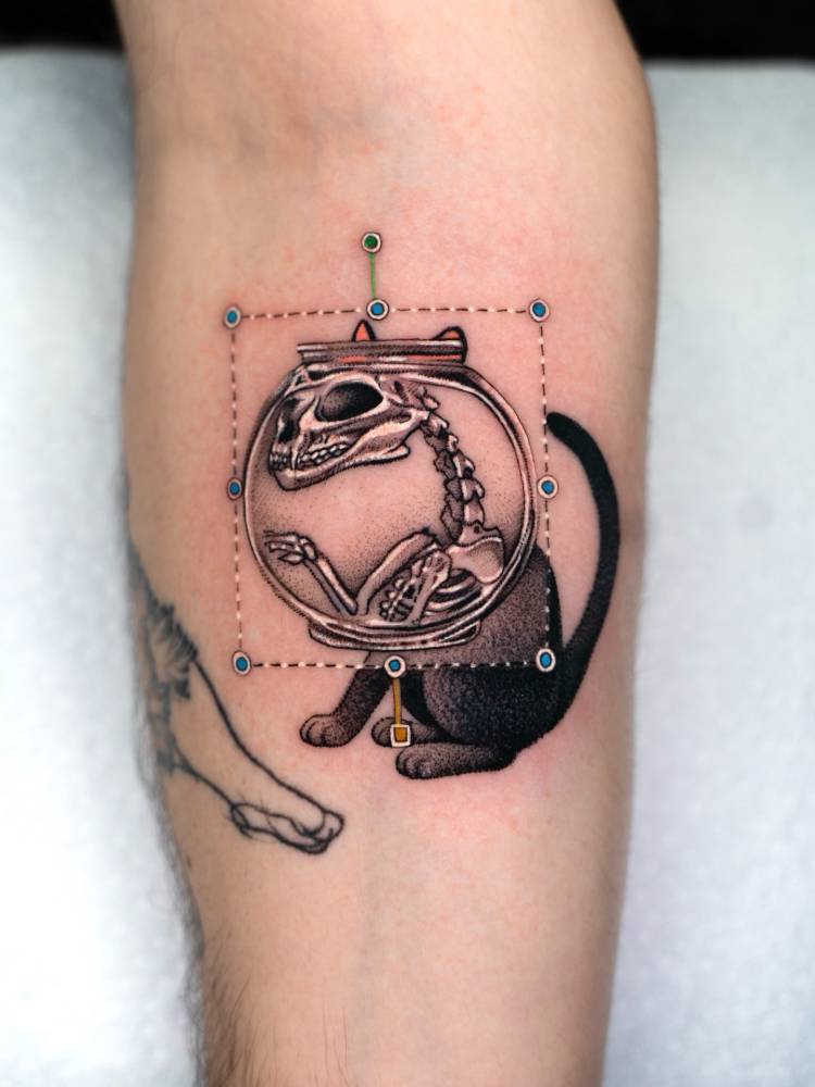 Cartoon style x-ray cat tattoo placed on the inner forearm.