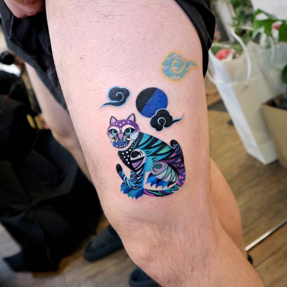 Tiger tattoo located on the thigh, done in oriental style.