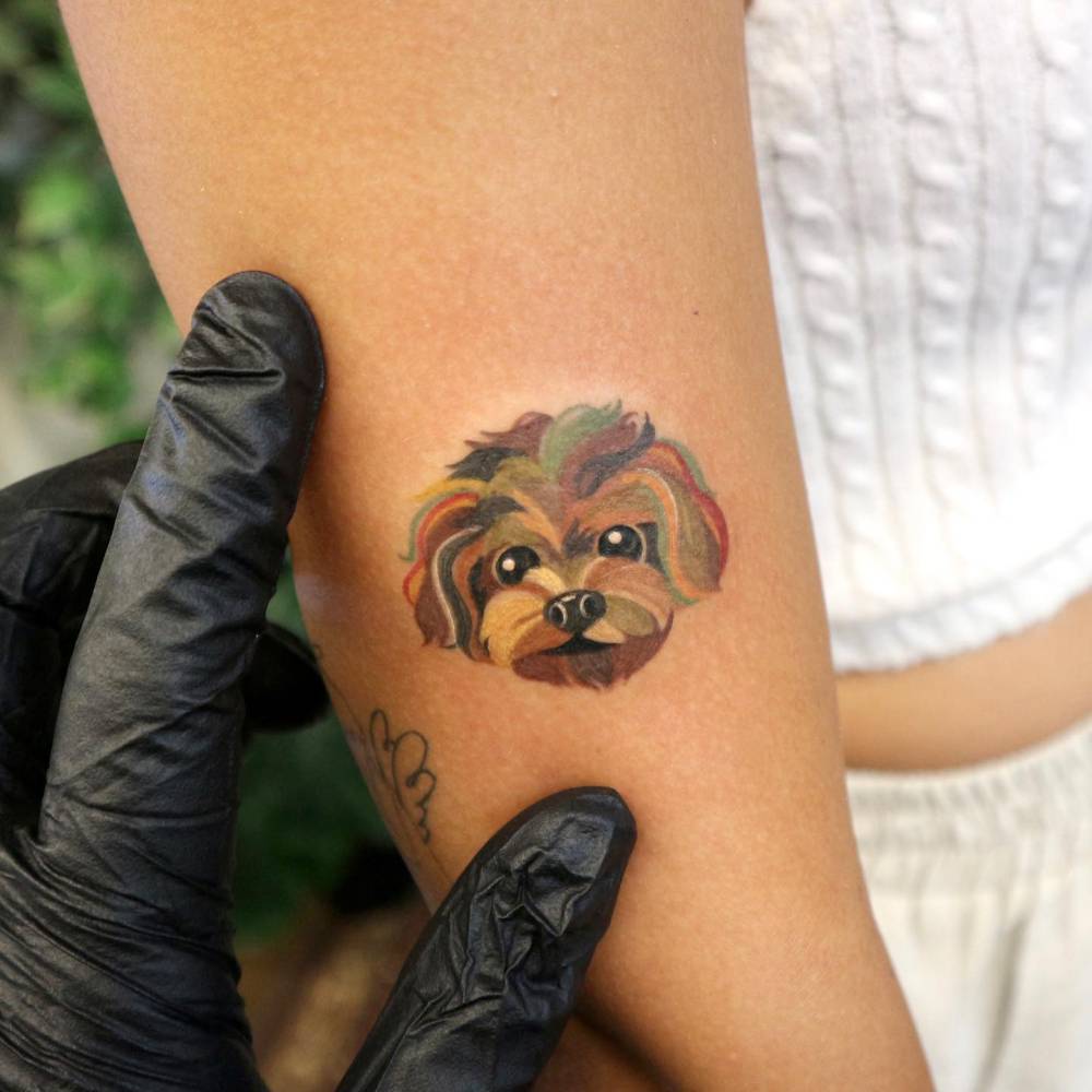 Yorkshire Terrier portrait tattoo located on the upper arm.