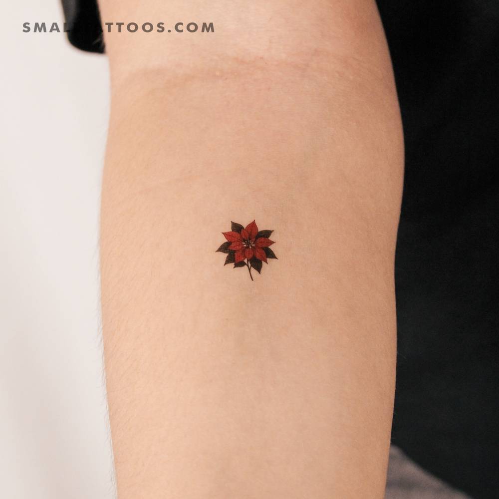 Poinsettia flower temporary tattoo located on the inner forearm.