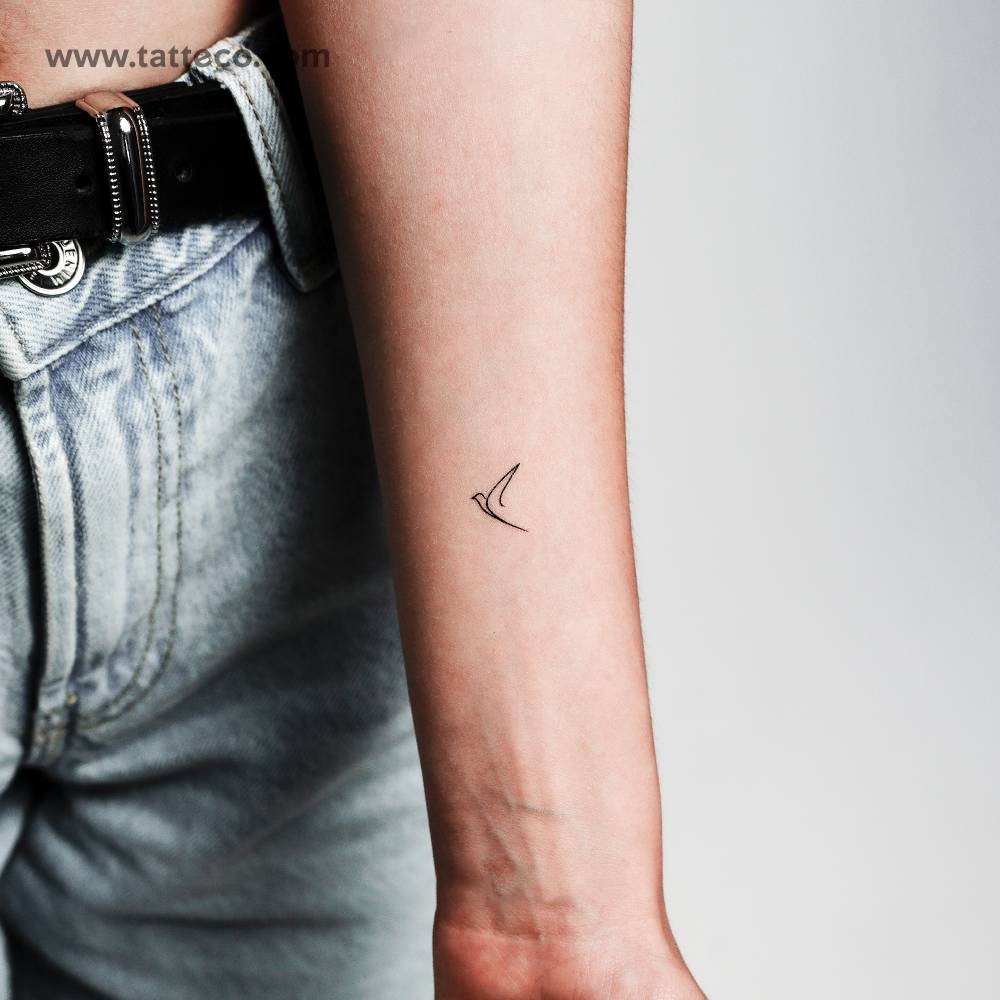One line bird temporary tattoo located on the inner forearm.
