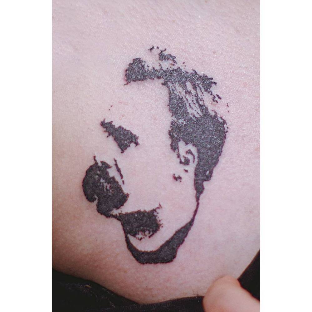 Nietzsche portrait tattoo in stencil style located on the hip.