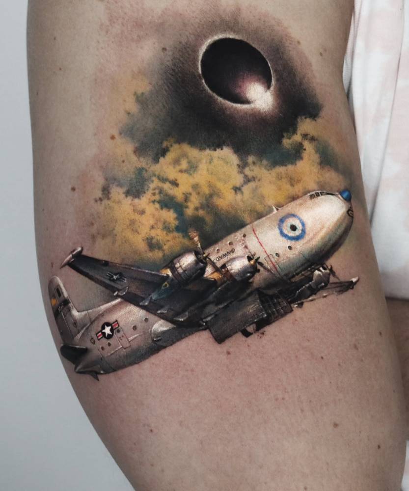Aircraft tattoo in micro-realistic style located on the upper arm.