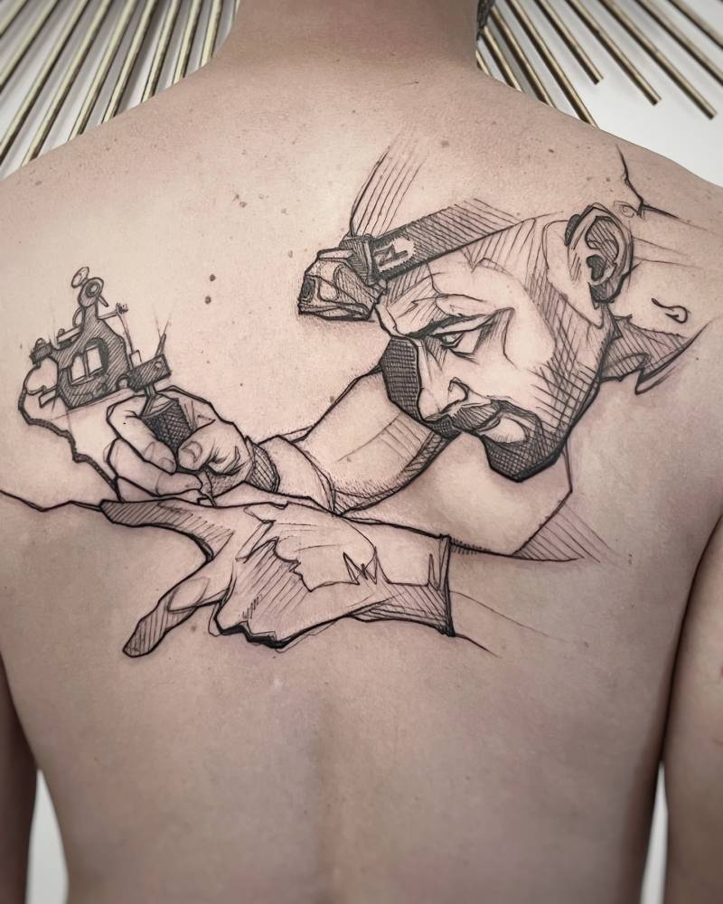 Tattoo artist in sketch work style tattooed on the back.