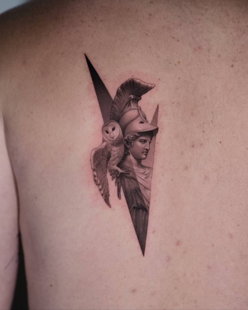 Micro-realistic style Athena tattoo located on the shoulder blade.