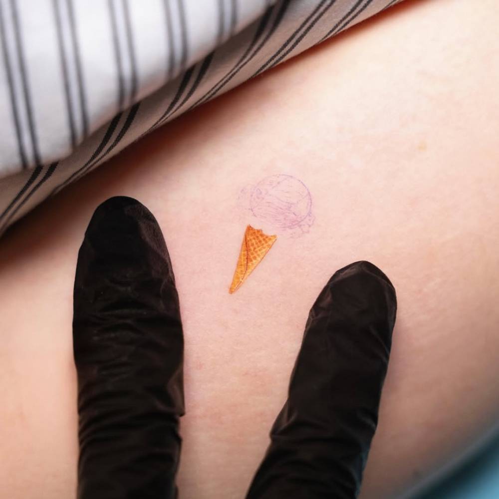 Ice cream cone tattoo located on the inner arm.