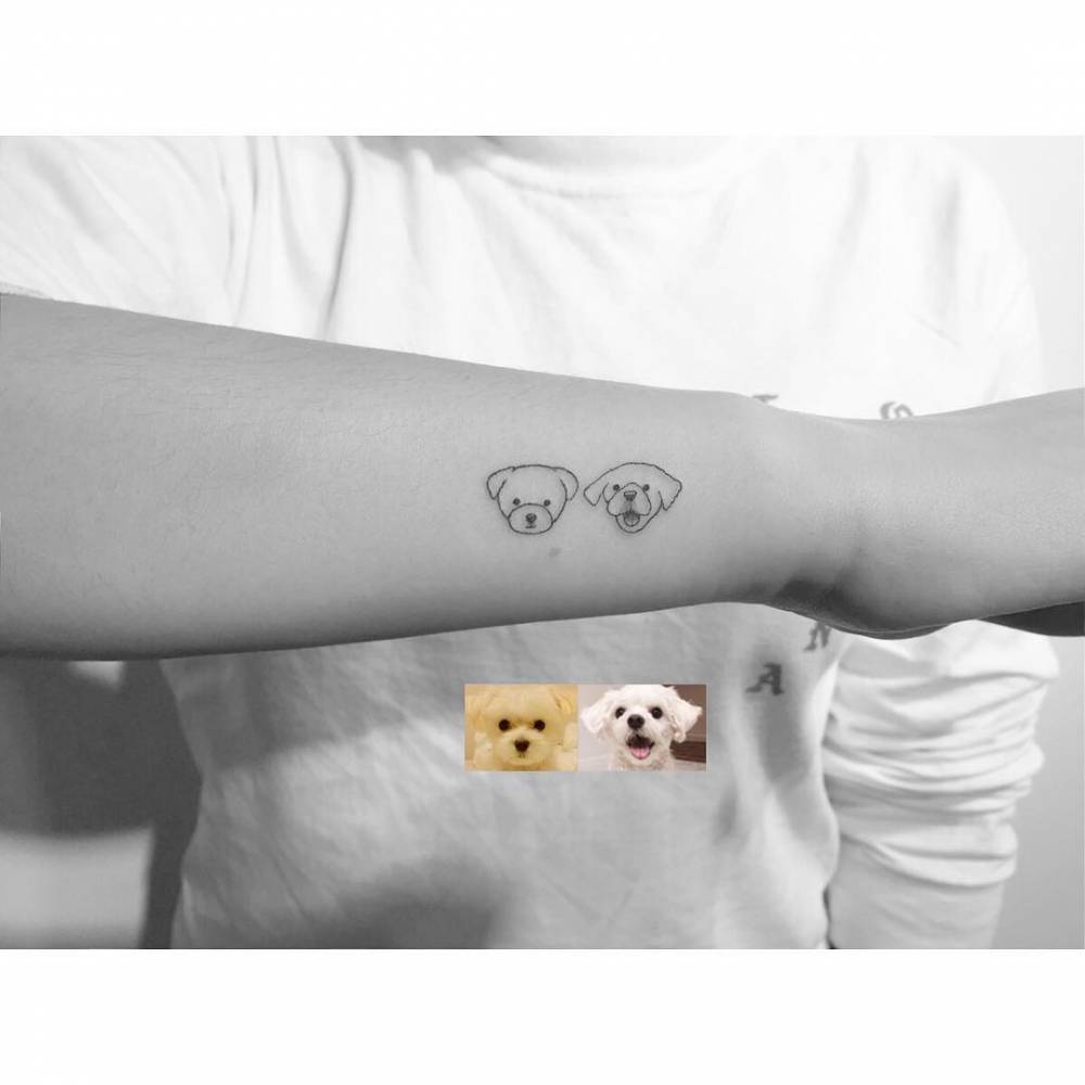 Minimalistic style dog portraits tattooed on the wrist.